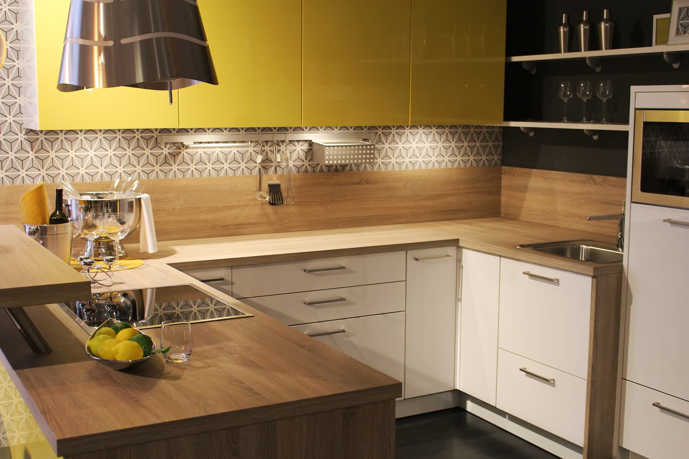 Kitchen renovation with timber benchtops, a patterned geometric splashback and olive-toned overhead cabinetry